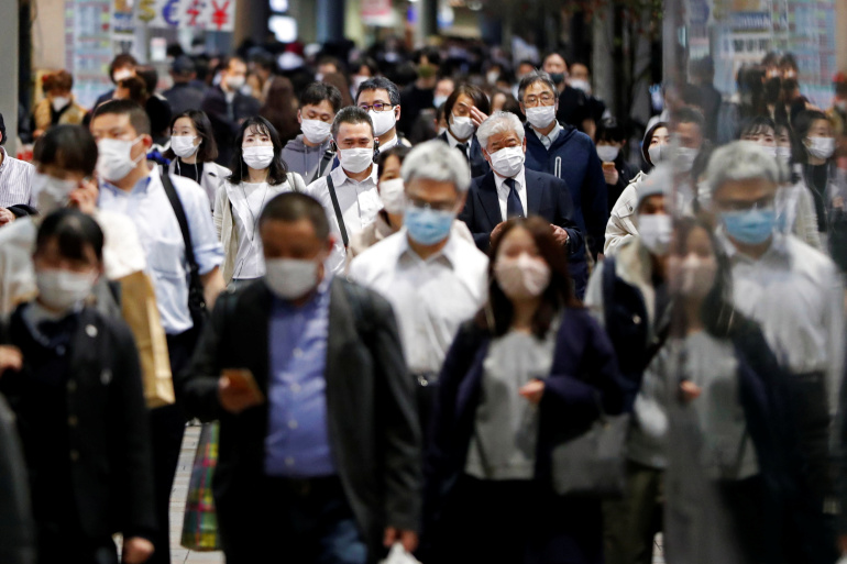 People wearing protective face masks walk on the street, amid the coronavirus disease (COVID-19) outbreak, in Tokyo