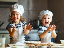 happy family funny kids are preparing the dough bake cookies in the kitchen